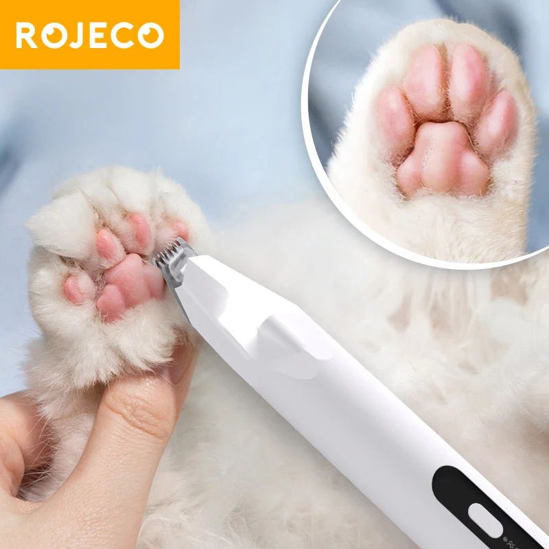 Using a quiet trimmer for dog paw pad grooming at home.